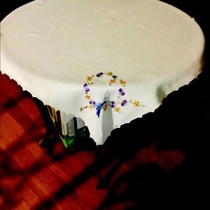 Vintage hand embroidered linen table cover with hand crocheted edge.